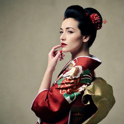 Woman in red kimono touching lips
