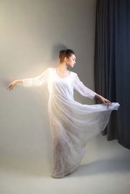 Woman dancing in white lace dress