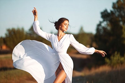 Woman dancing in flowing white dress