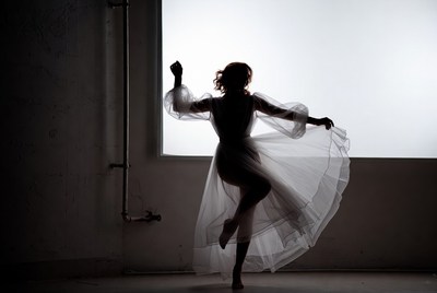 Silhouette woman dancing in sheer dress
