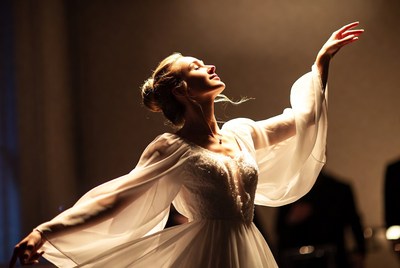 Woman dancing in flowing white gown