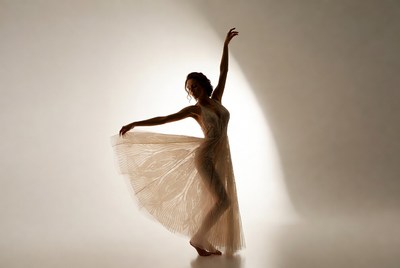 Woman dancing in flowing dress silhouette