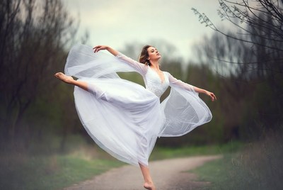 Woman dancing ballet in white dress