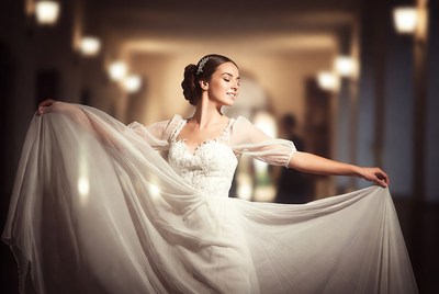 Woman twirling in white wedding dress