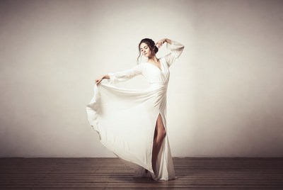 Woman dancing in flowing white gown
