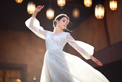 Woman dancing in white gown