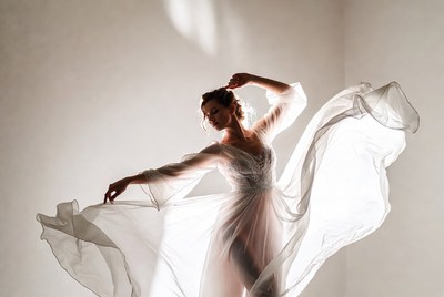 Woman dancing in flowing white gown