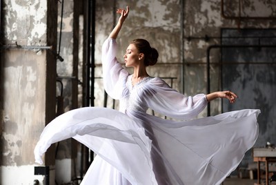 Woman dancing in white flowing dress