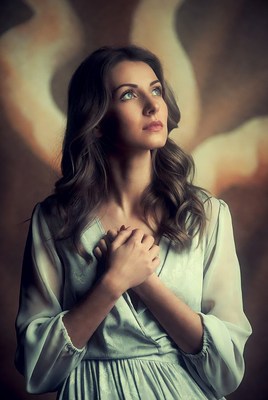Woman praying with hands clasped
