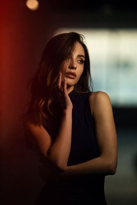 Woman with hand on cheek in dramatic lighting