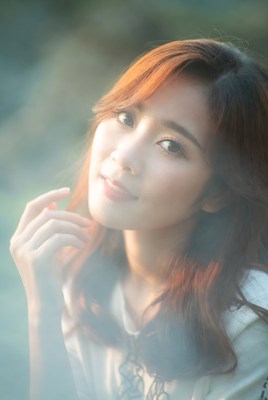 Asian woman with red hair smiling