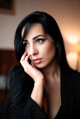 Beautiful woman touching face in suit