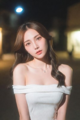 Asian woman in white off-shoulder top at night