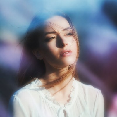 Woman with flowing hair in blue bokeh