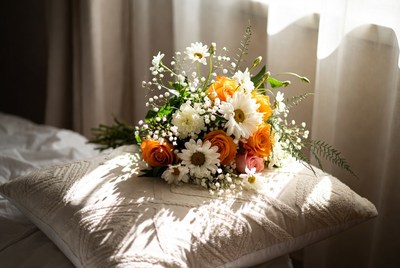 Orange Daisies Bouquet on White Pillow