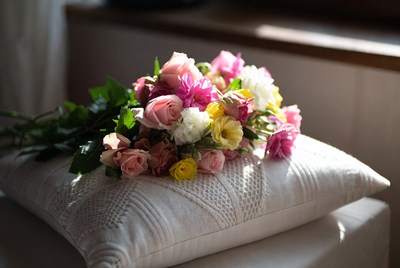 Colorful Roses Bouquet on White Pillow