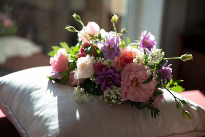 Pink and Purple Flowers on White Pillow