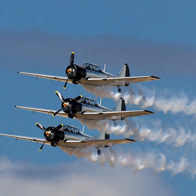 Three Silver T-6 Texan Planes Flying in Formation