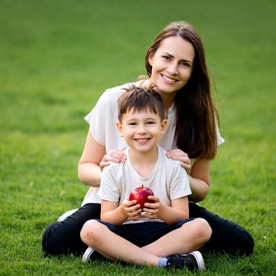 Mother and boy holding red apple