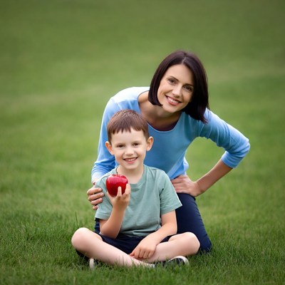 Mother and boy holding red apple