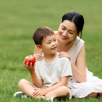Asian mother and son with red apple