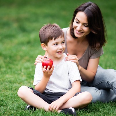 Mother and boy holding red apple