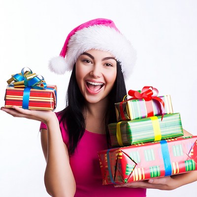 Smiling Latina woman holding Christmas gifts