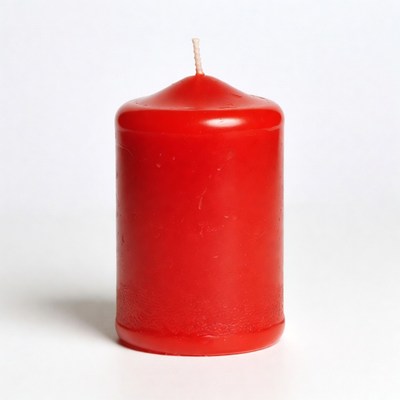 Red pillar candle on white background