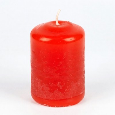 Red pillar candle on white background