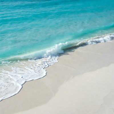 Turquoise Ocean Waves Crashing on White Sand Beach