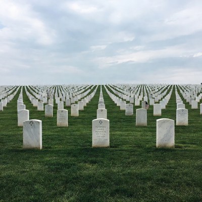Rows of White Headstones in Cemetery