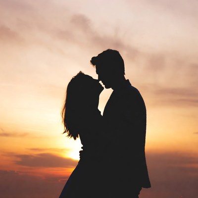 Silhouette couple kissing at sunset