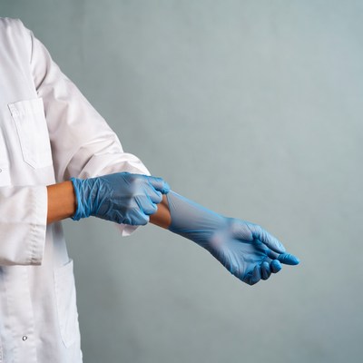 Woman putting on blue gloves