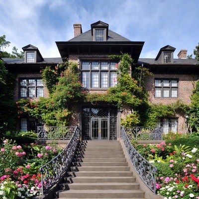 Brick Mansion with Ivy and Flower Garden