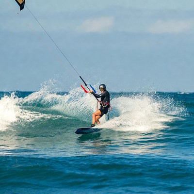 Man kitesurfing on ocean waves