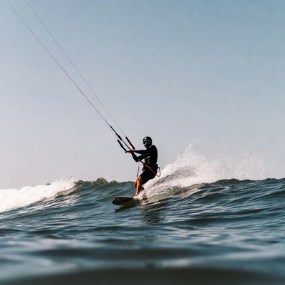 Man kitesurfing on ocean waves