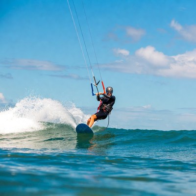 Man kitesurfing on ocean wave