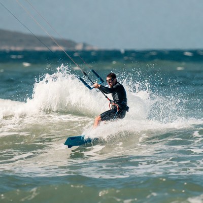 Man kite surfing on ocean waves