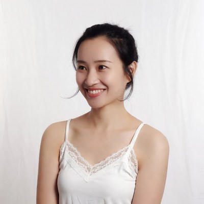Asian woman smiling in white lace camisole