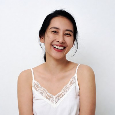 Asian woman smiling in lace camisole