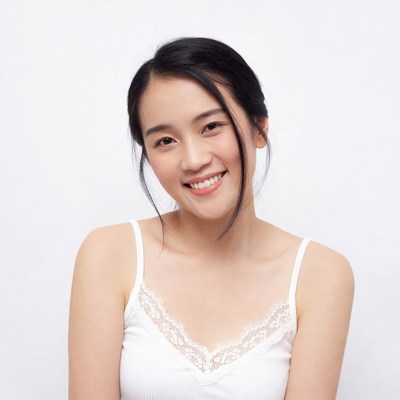 Asian woman smiling in lace camisole