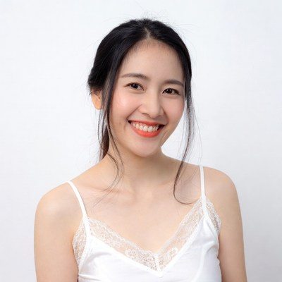 Asian woman smiling in white camisole