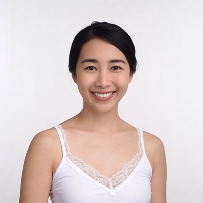 Asian woman smiling in white lace camisole