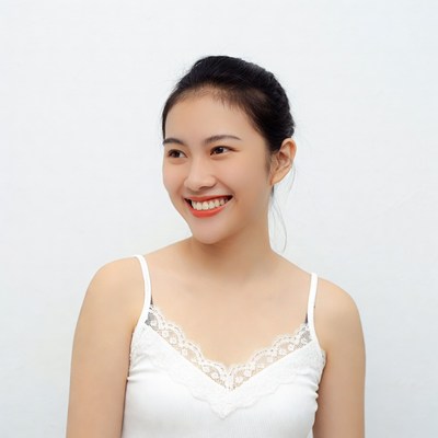 Asian woman smiling in lace camisole