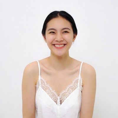 Asian woman smiling in white lace top
