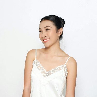 Asian woman smiling in lace camisole