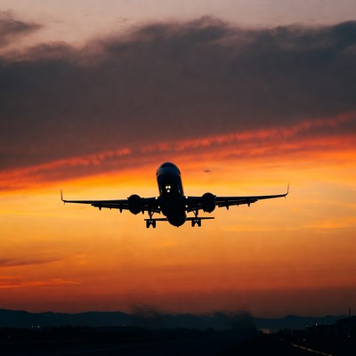Airplane flying at sunset silhouette
