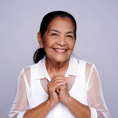 Asian elderly woman smiling with clasped hands