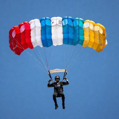 Man skydiving with colorful parachute
