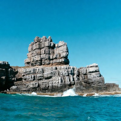 Towering Rock Formation by Ocean Waves